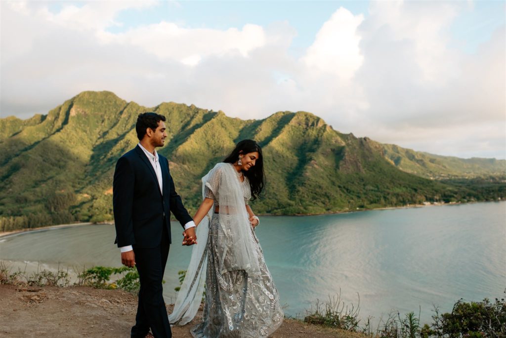 Bride and groom walking at Crouching Lion hike in Kauai for their adventure elopement.