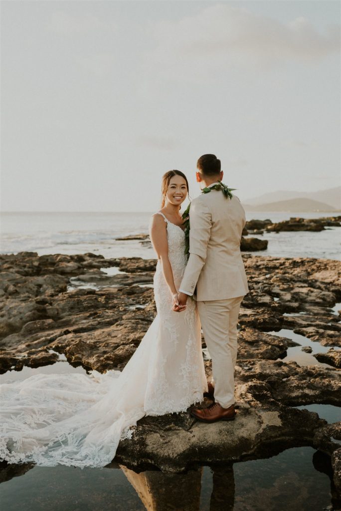 Bride and Groom standing on the beach for their Hawaii elopement.