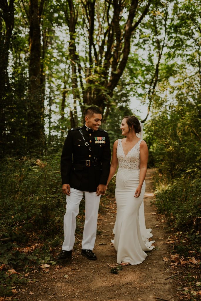 Bride and groom walking down a secluded forest trail before their wedding ceremony in Portland, Oregon
