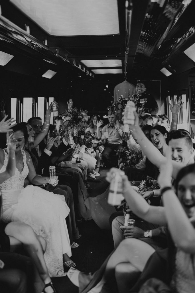 Bridal party riding in the party bus after wedding ceremony. 