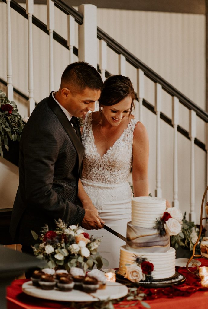 Bride and groom cutting cake during Portland wedding reception