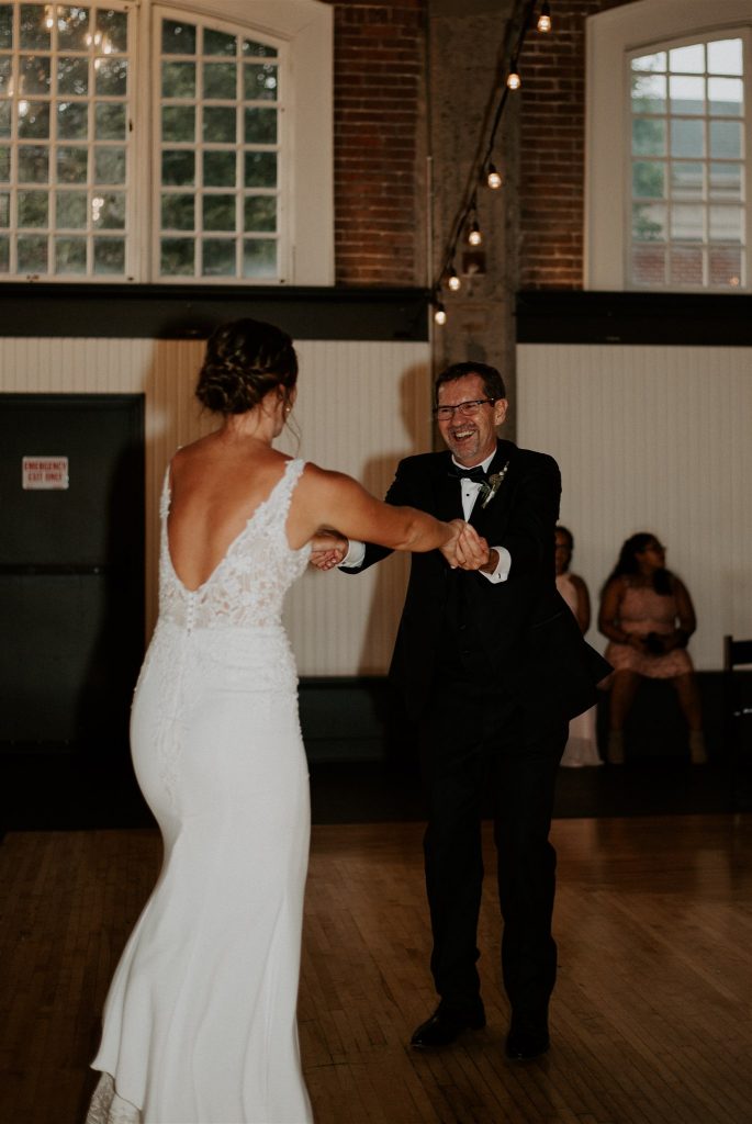 Father laughing during father-daughter dance