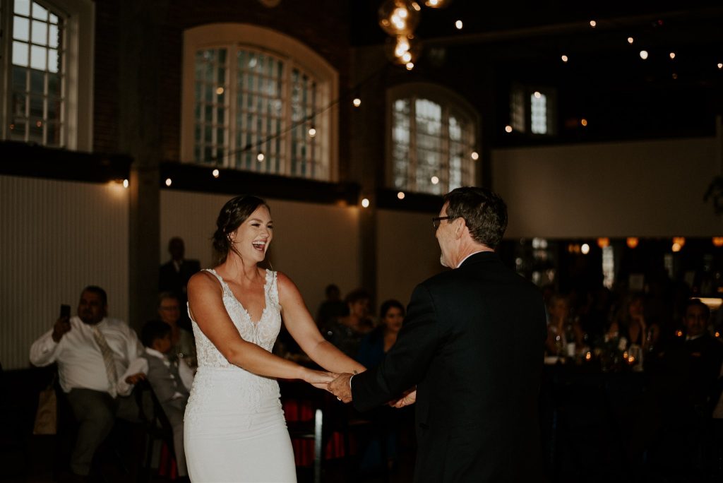 Bride laughing during father-daughter dance
